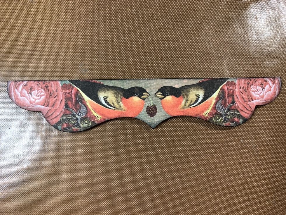 Cut or die-cut a decorative shape or border no wider than the bottom panel of your card. You can also use a punch-out that coordinates well with your papers, like I have.