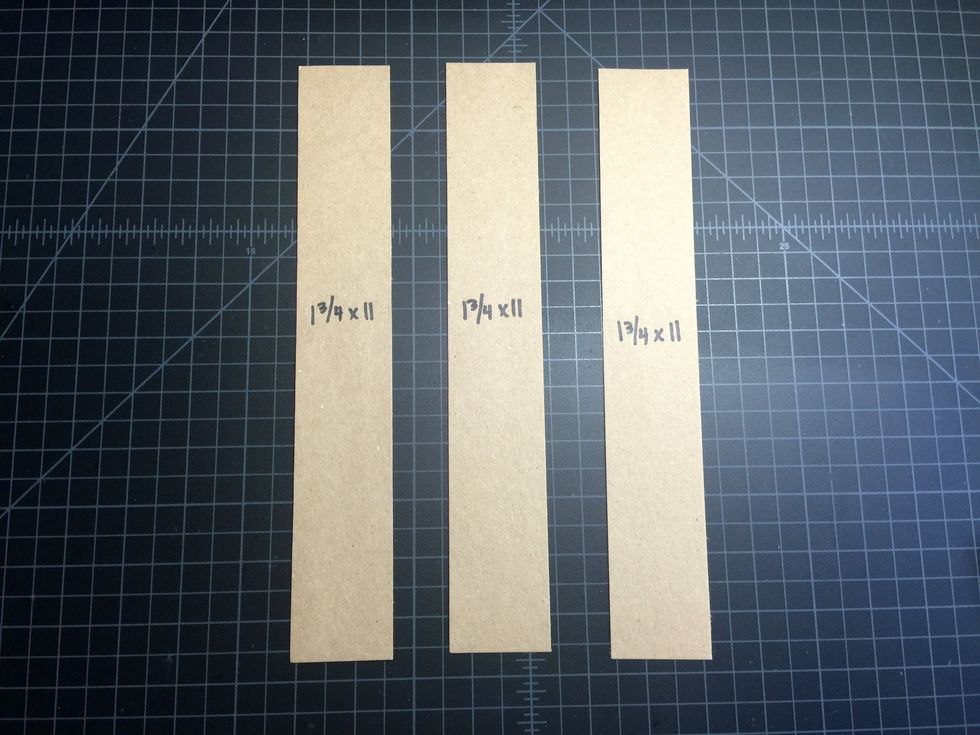 Cut out 3 strips of card stock in a color of your choice. I'm using Kraft card stock from Hobby Lobby, it goes well with World's Fair. We'll use these strips for the hinges: (3) 1 3/4" x 11".