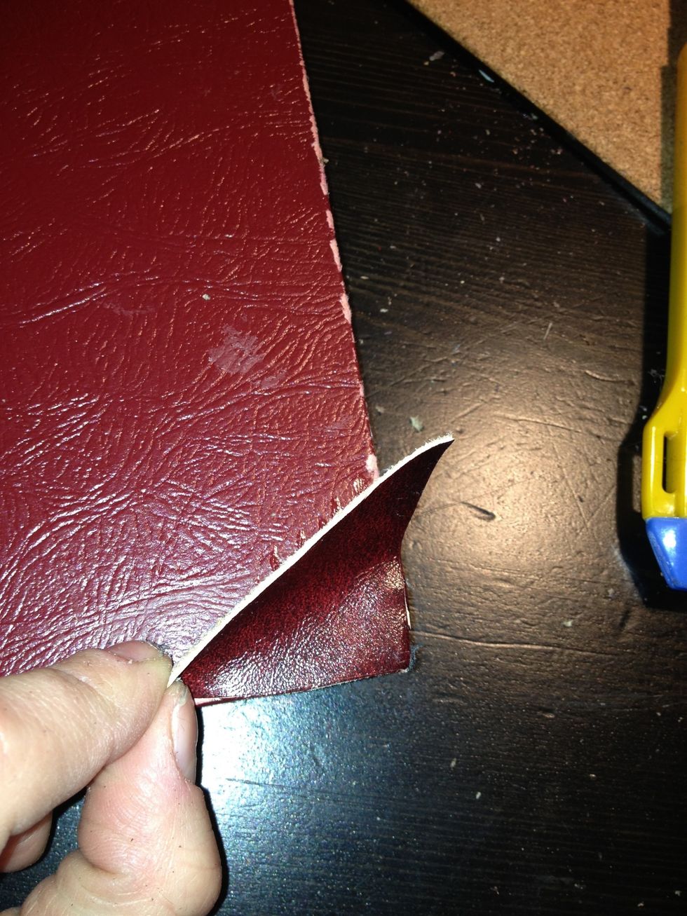 Cut out 4 triangles out of the leather scraps and glue them to the corners on the book - 2 on the front, and 2 on the back.