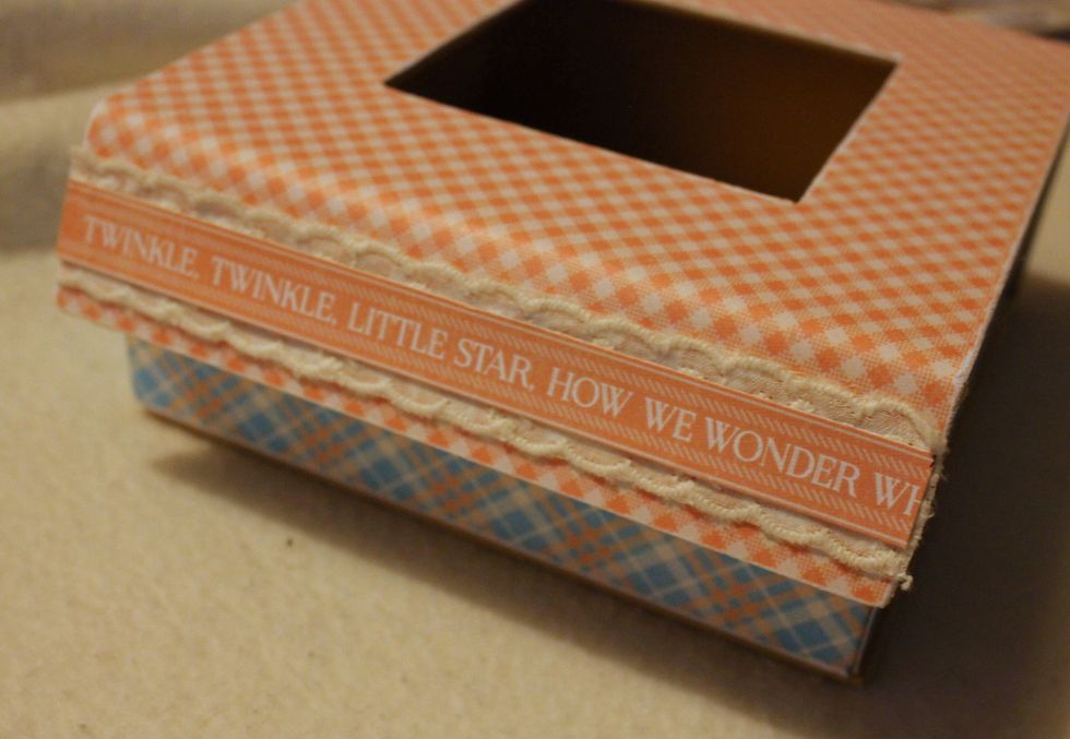 Cut out a border with text from one of the 'Precious Memories' papers. Attach it, together with a piece of lace, to the front side of the box.