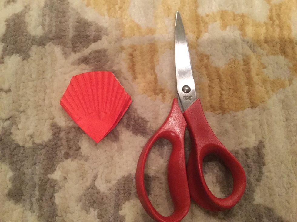 Cut out a leaf shape on the top of the folded cupcake liner.