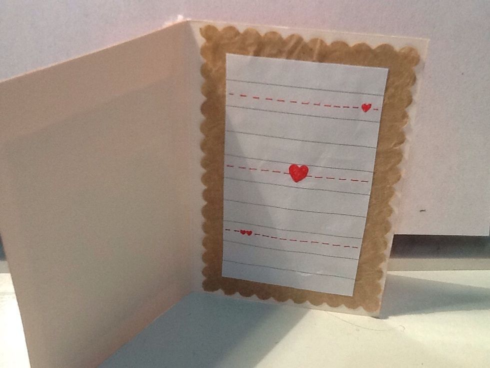 Cut out a piece of lined paper to fit (as seen in photo). Glue it in using the same methods before, and draw designs on it with a red pen.