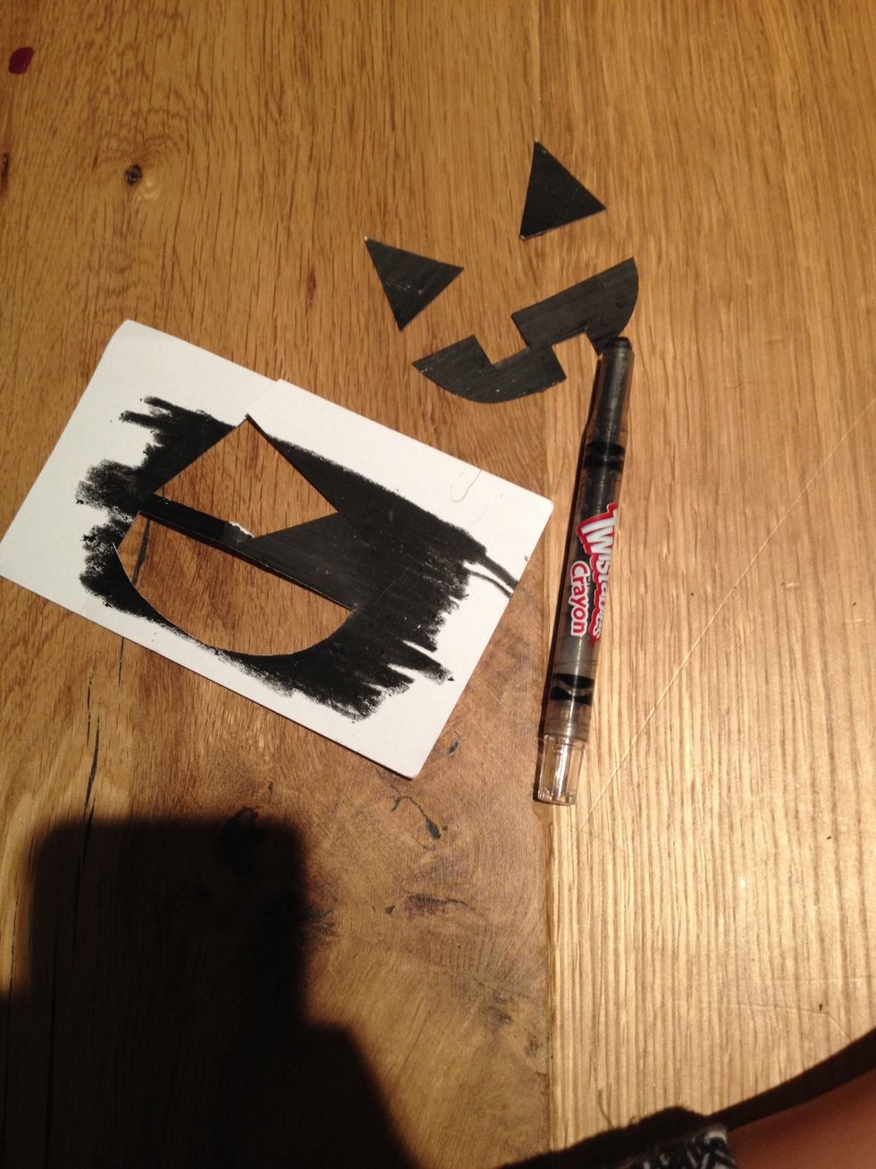 Cut out a pumpkin face of your liking with the black piece paper