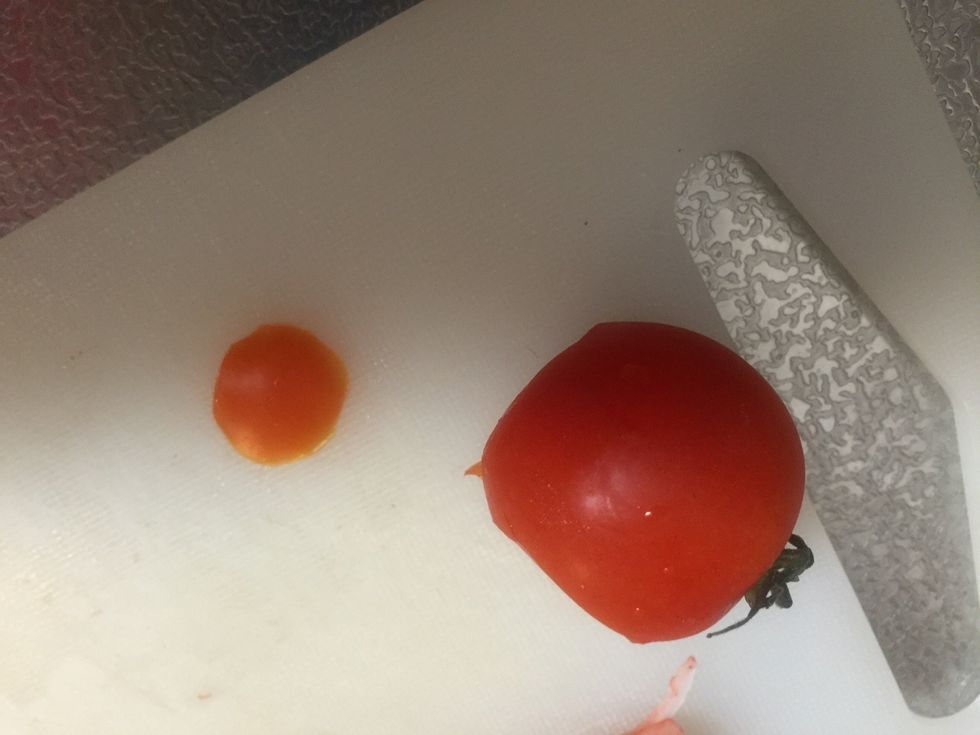 Cut out a small piece from a tomato and put it on the reindeer's face.