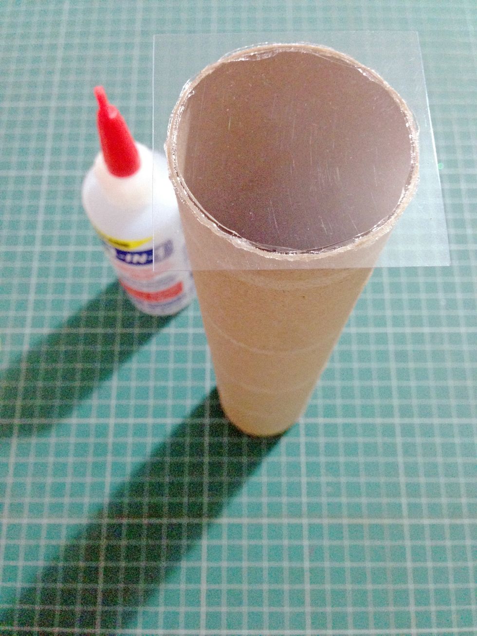 Cut out a small piece of acetate and glue on top of the kitchen roll... Make sure the acetate is free of dust prior in gluing...