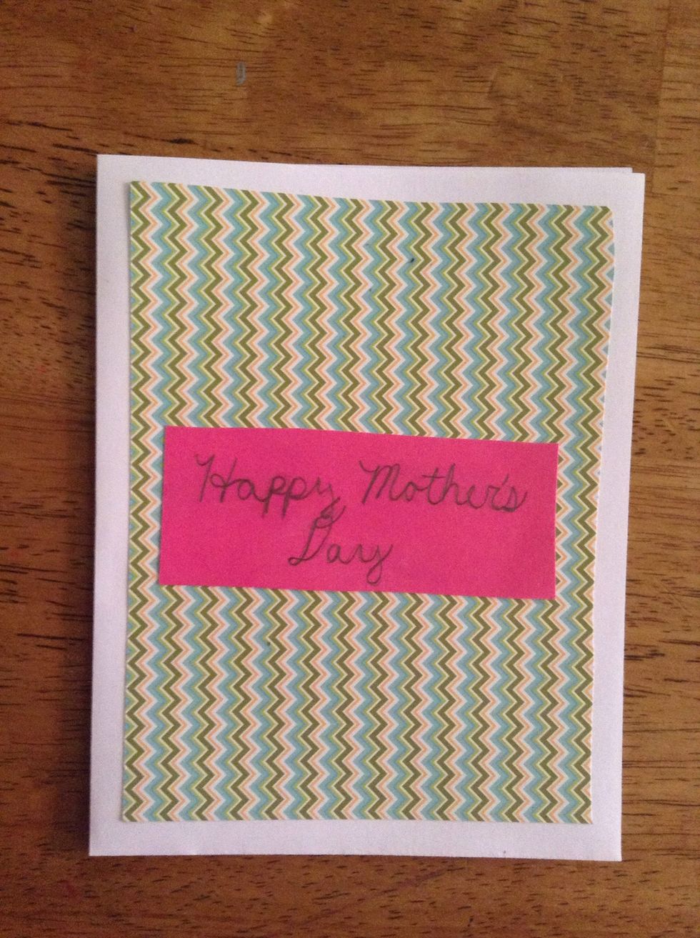 Cut out a small rectangle in a solid-colored paper and write your message on it. Glue this in the center of the front of the card.