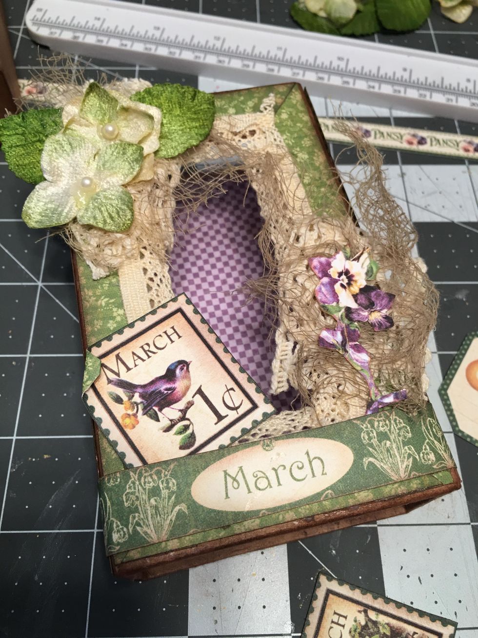 Cut out a stamp from the patterned paper, curl one corner and glue to the bottom left side.