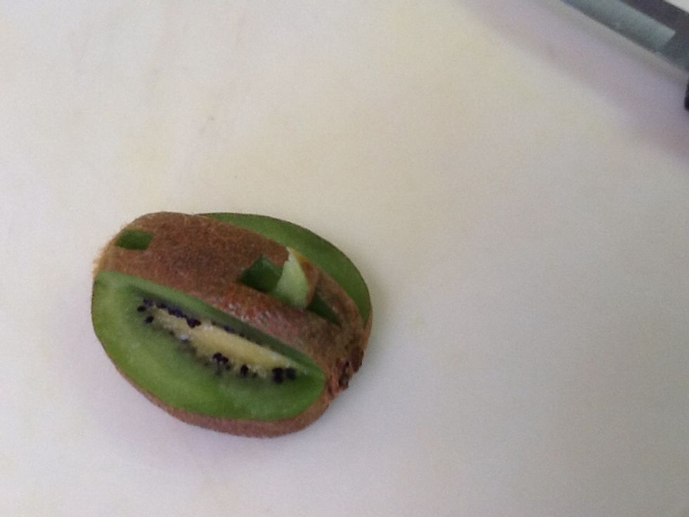 Cut out a triangle running from about midpoint to the top of the center. It may take some time to get the triangle out. After it is out cut off some of the triangle to give it a curve.