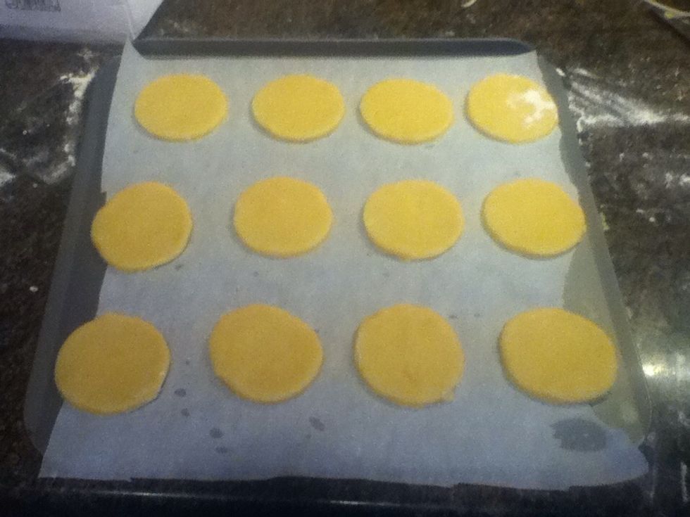 Cut out as many as possible by re-rolling. Line your baking tray with some parchment paper...sprinkle a couple of drops of water on the tray to help the paper stick! Place the biscuits on the tray! \ud83d\udc95