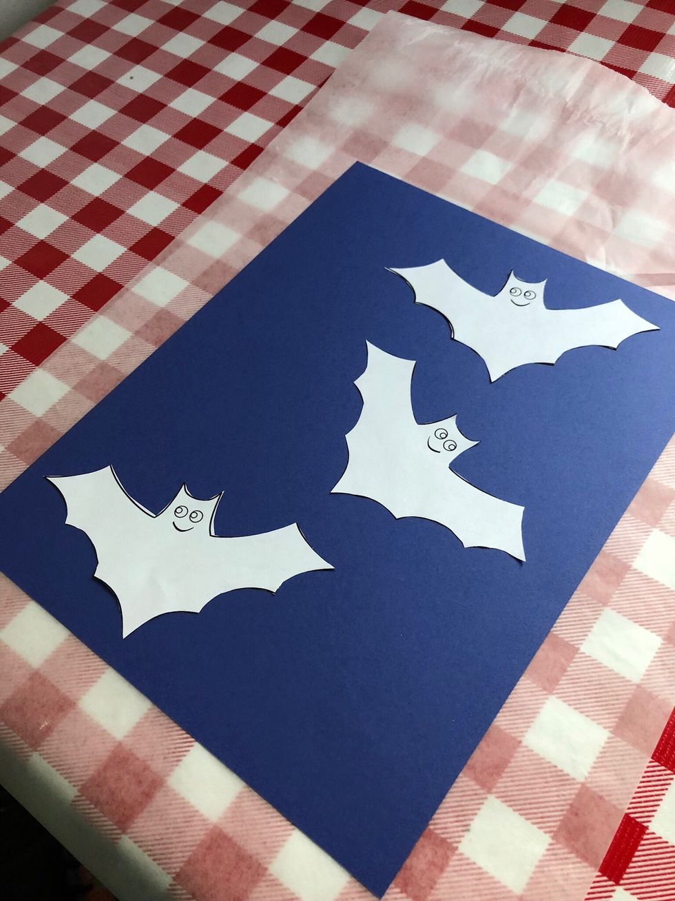 Cut out bat templates, use double stick tape to tape bats down on construction paper.