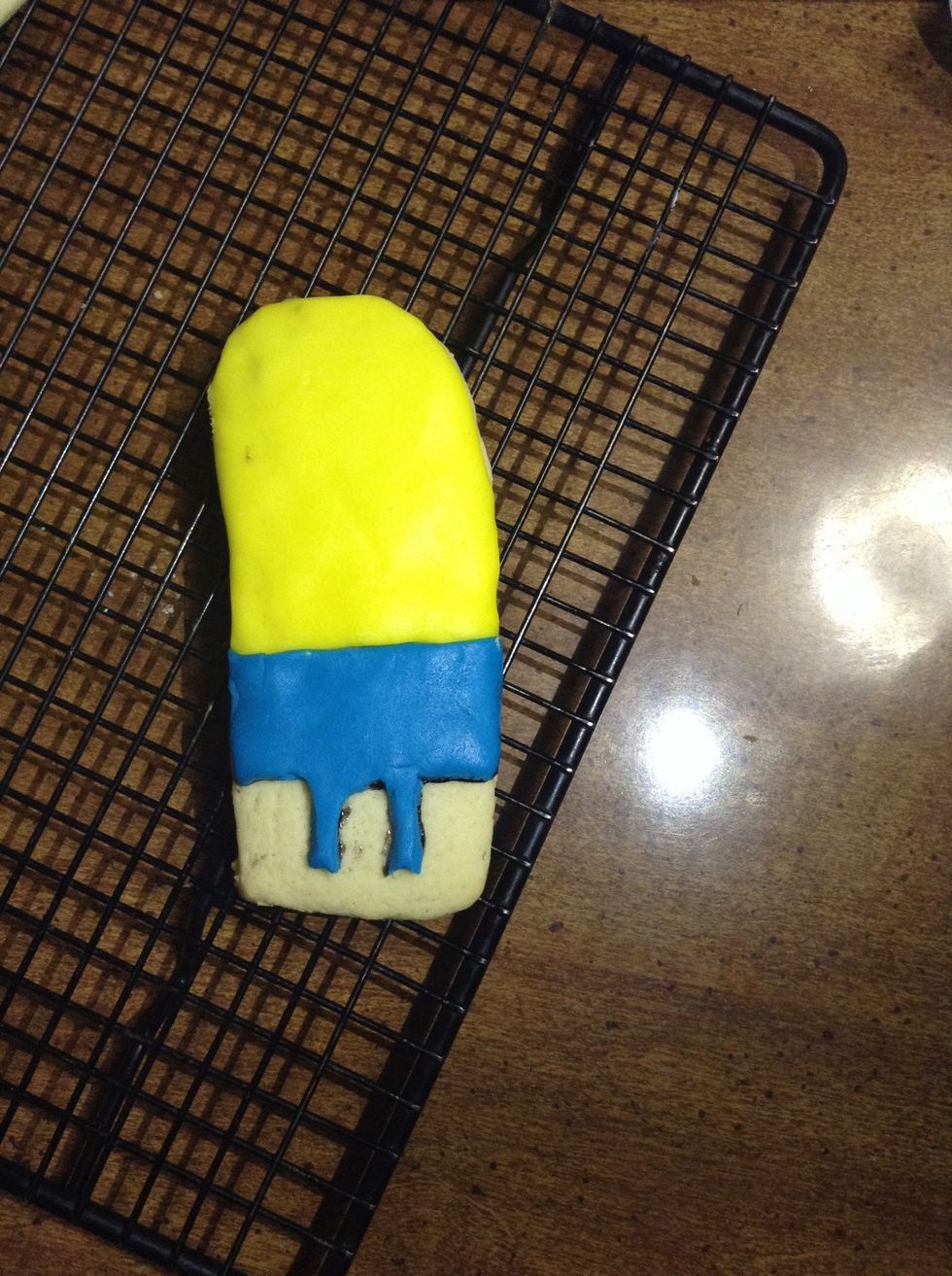 Cut out blue fondant to form pants for the minion