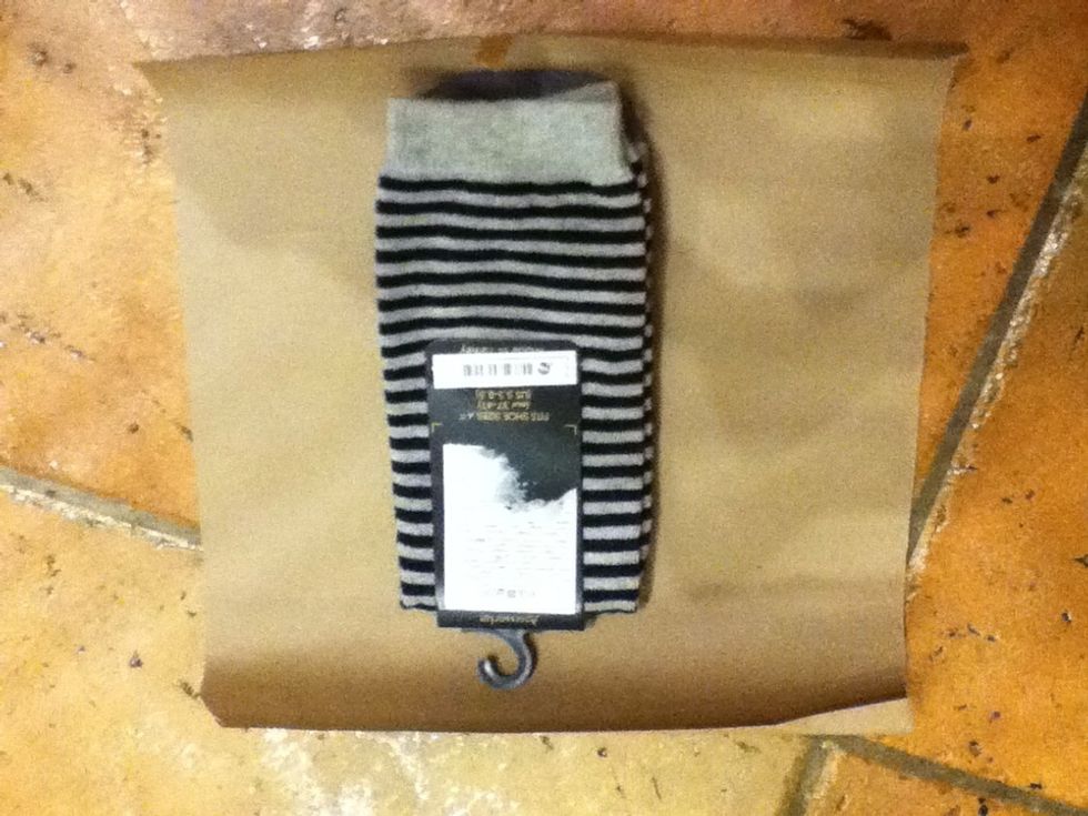 Cut out brown paper big enough to wrap your present properly. Place the item face down.