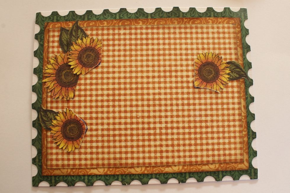 Cut out four sunflowers from one of the papers in the Graphic 45 French Country 8" Pad and attach them to your card in the way shown in this photo.
