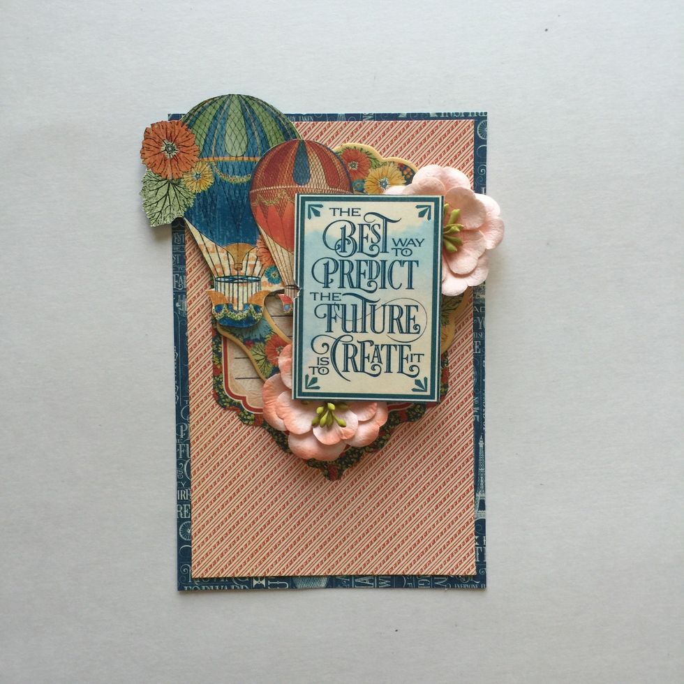 Cut out inspirational quote box from World's Fair 12x12 sheet and place as pictured, placing 2 flowers under opposite corners. Make sure Tag still peeks out from under bottom flower. Glue in place.