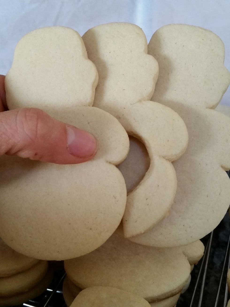 Cut out shapes. 3 cookies needed per serving. 2 of the men need to be solid. 1 needs a circle cut out in center with an "exit" cut out to of the bottom. This holds the sprinkles.