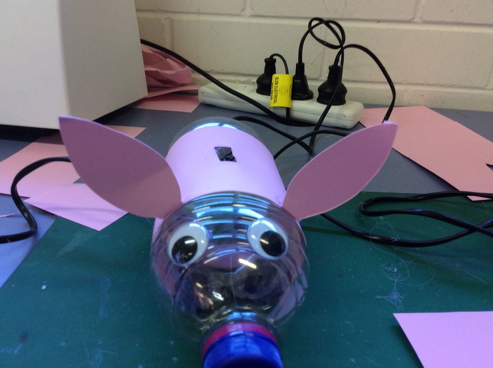 Cut out some ears for your piggy and hot glue them right on.