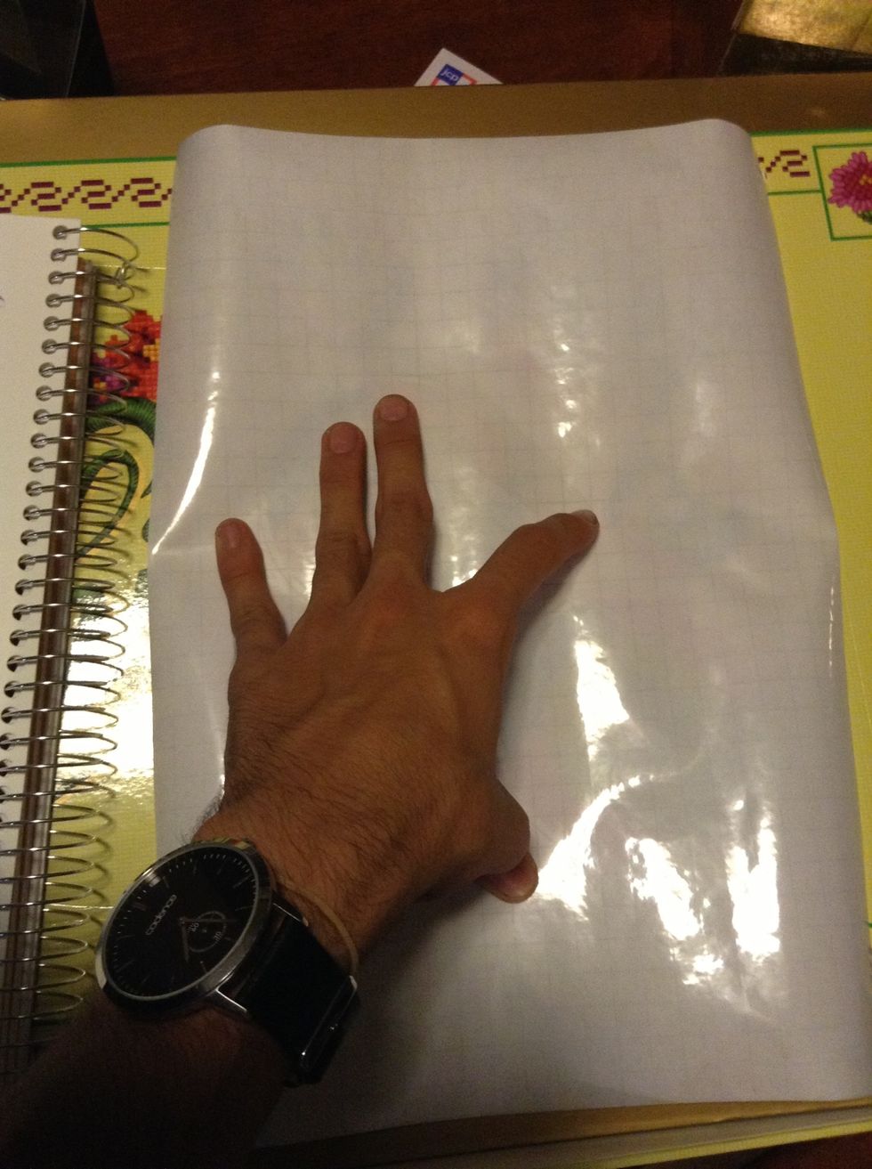 Cut out some laminating paper that exceeds the dimensions of your sticker paper. Limit the excess laminating paper to save up for later use.