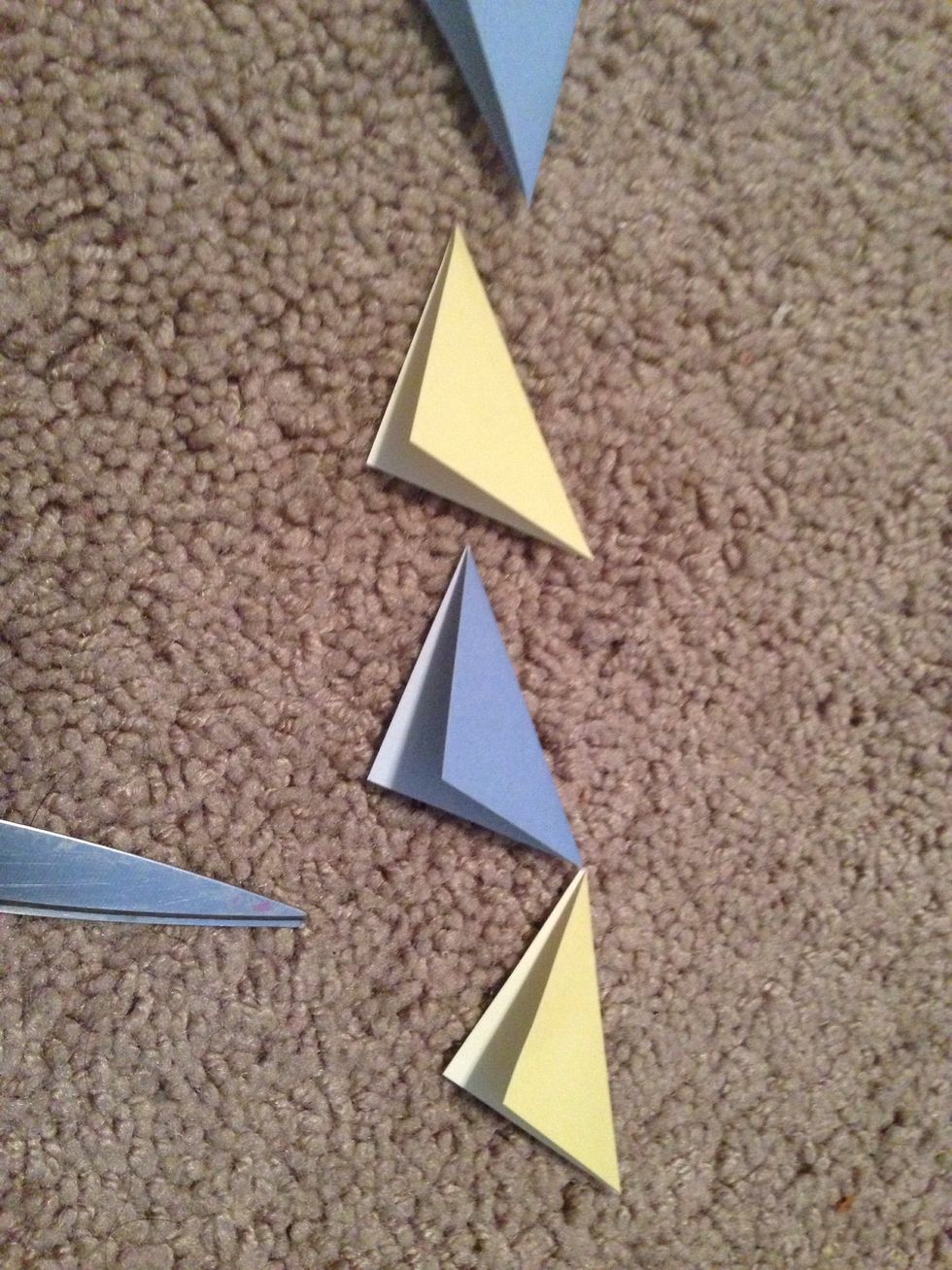 Cut out squares of paper, any color you desire, and fold diagonally!