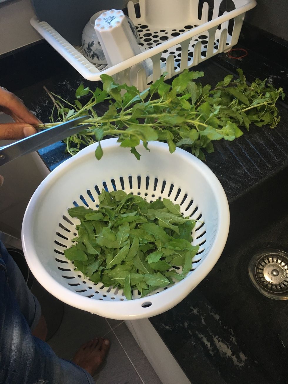 Cut out the basil leaves into a basket to prep them for frying in with the minced pork later on.