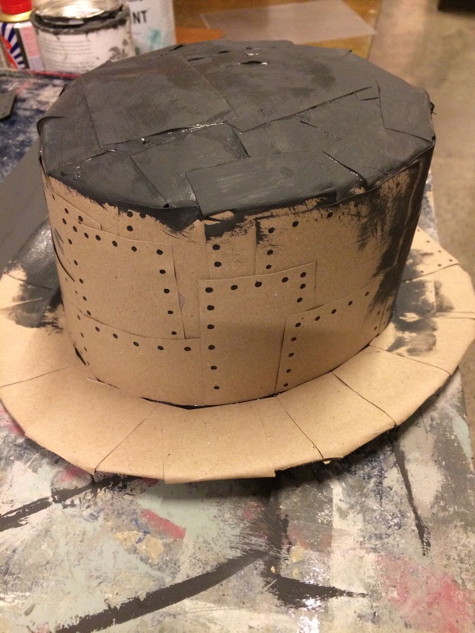 Cut out the carton in small squares and glue them on the hat. And Paint the hat Black with Chalk Paint.