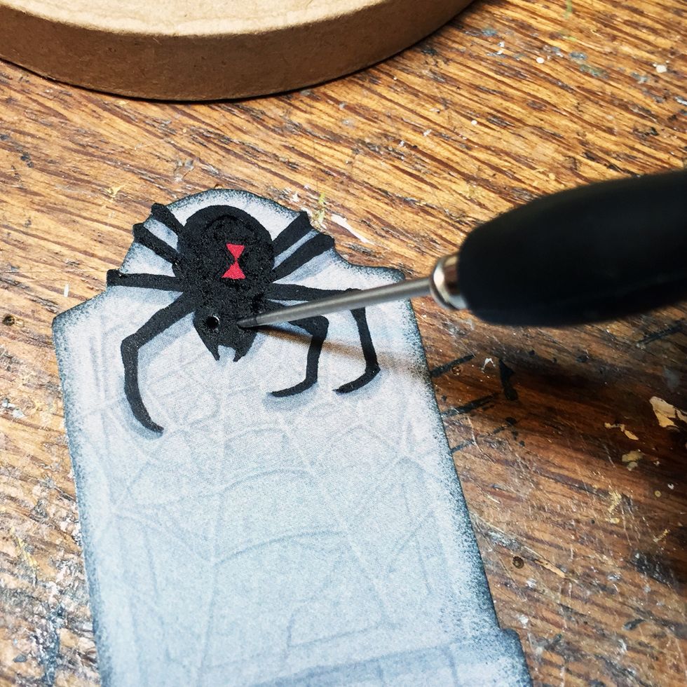 Cut out the image you want to use. Color parts of the image and ink the edges if you want to do that. Using an awl or other pointed tool poke holes through the paper where you want the lights.