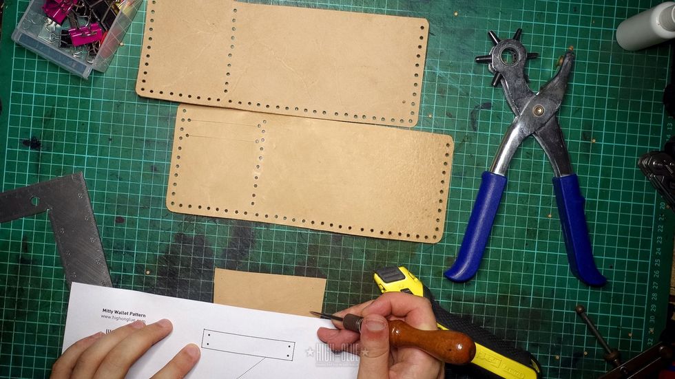 Cut out the strip that holds the flap down. We\u2019ll align the stitching holes in the next step