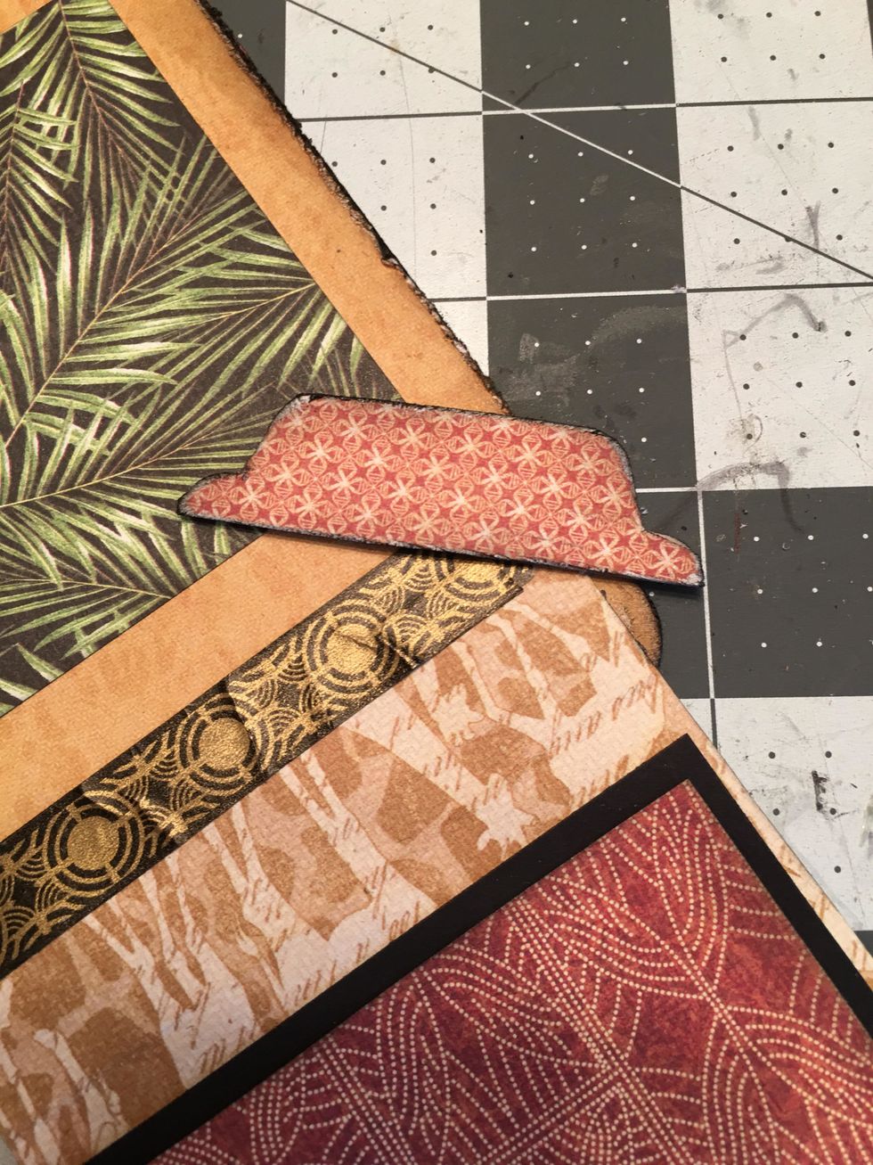 Cut out the tab from the patterned paper with scissors, distress, sand and ink all edges of the tab.