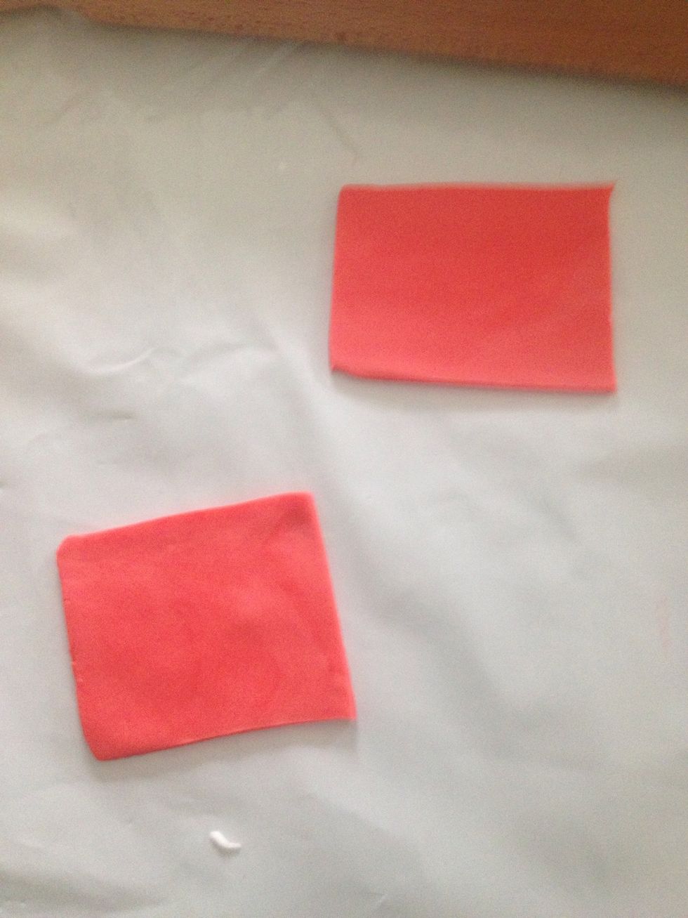 Cut out two squares out of the red icing