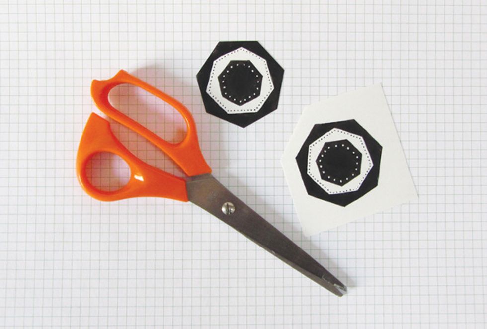 Cut out your designs, place them on the baking tray and in the oven. The heat will curl and shrink your designs. Within a minute the plastic will uncurl and lie flat on the tray. Remove from oven.