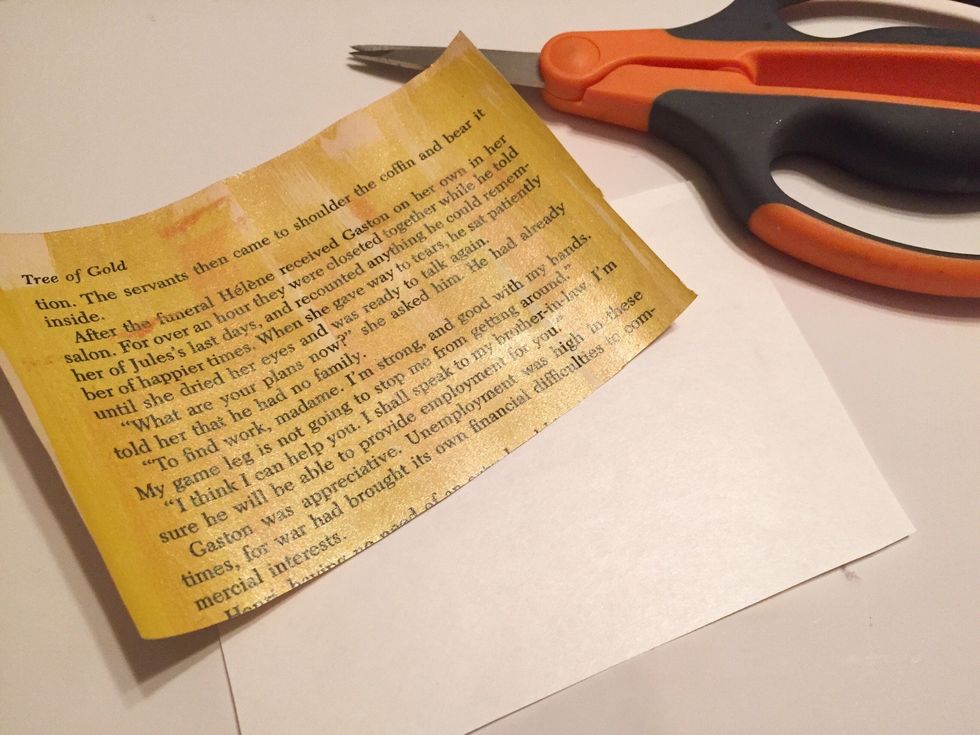 cut page of color you want to start with in half - in this case a yellow page for the "moon". then cut a piece of Artist-Tac a little bit larger.