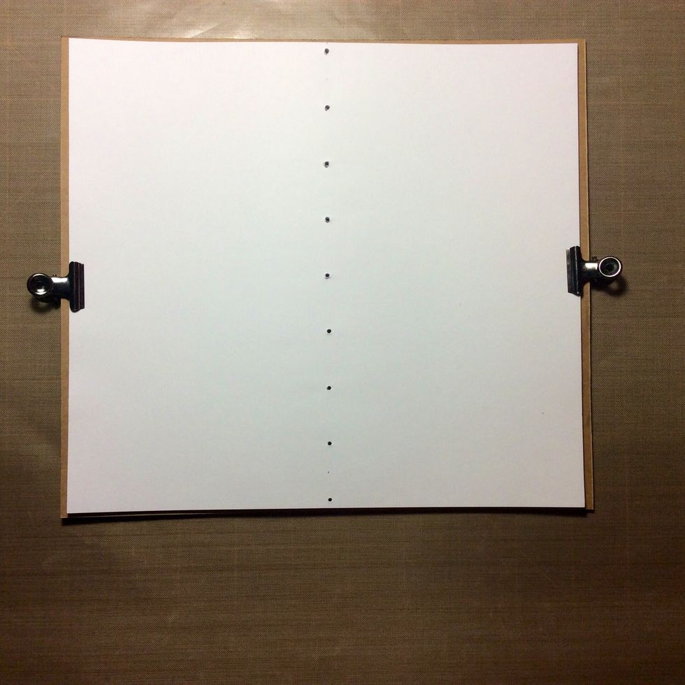 Cut pages in desired number from white paper to fit the kraft Card stock piece. Clip to card stock and punch holes 1 inch apart down the centre