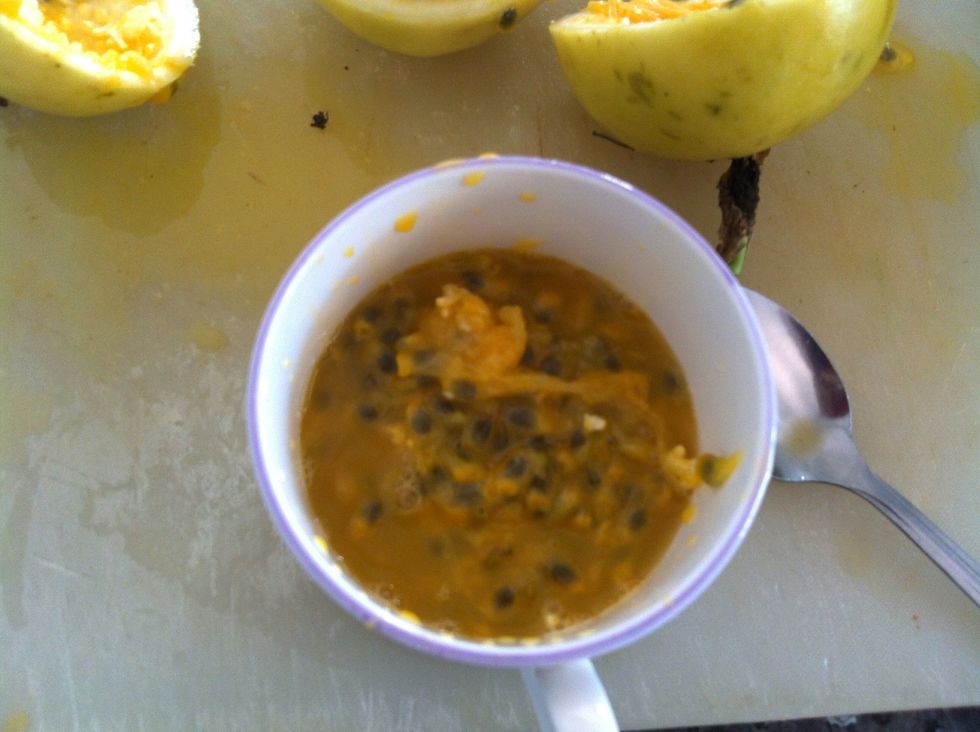 Cut passion fruits in half and scoop out seeds