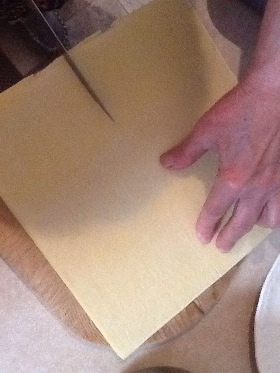 Cut pastry in half and place in greased tray