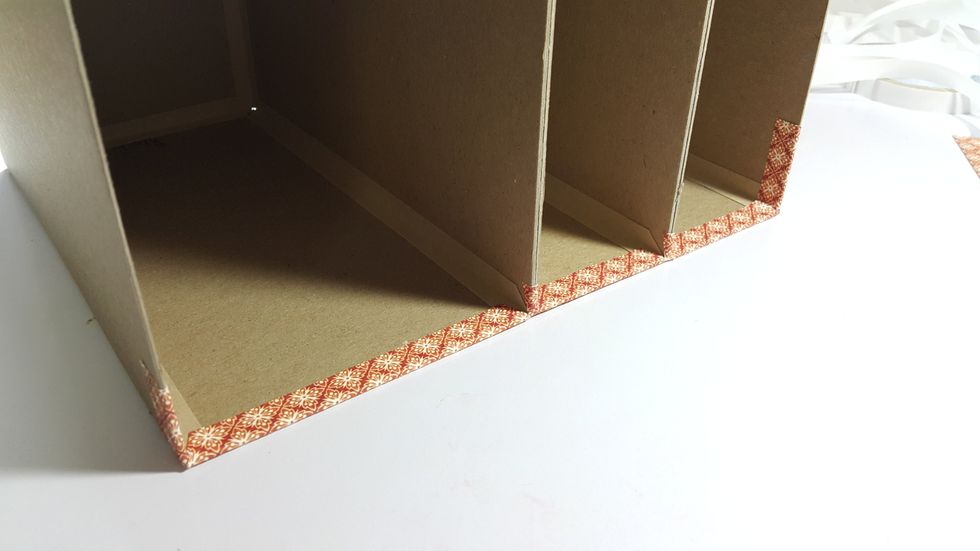 Cut pattern paper strips of 1" width to cover the edges.