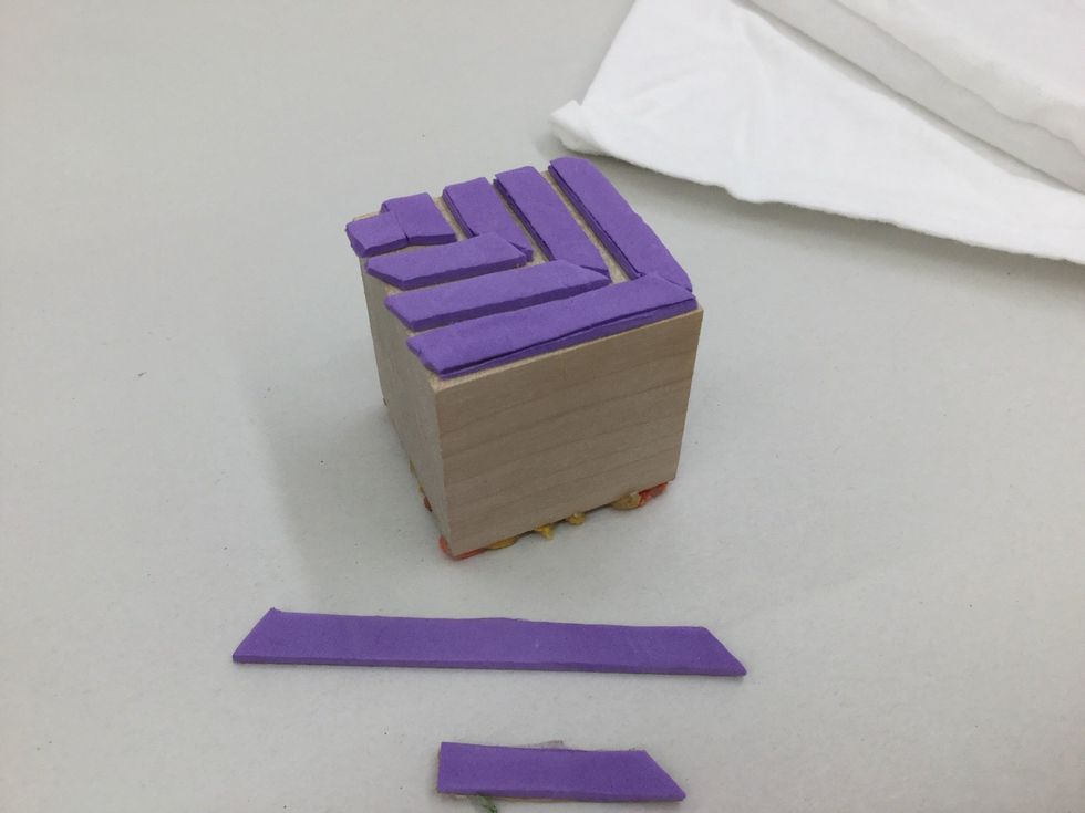 Cut pieces of adhesive backed craft foam and adhere to block for one of your stamp designs.