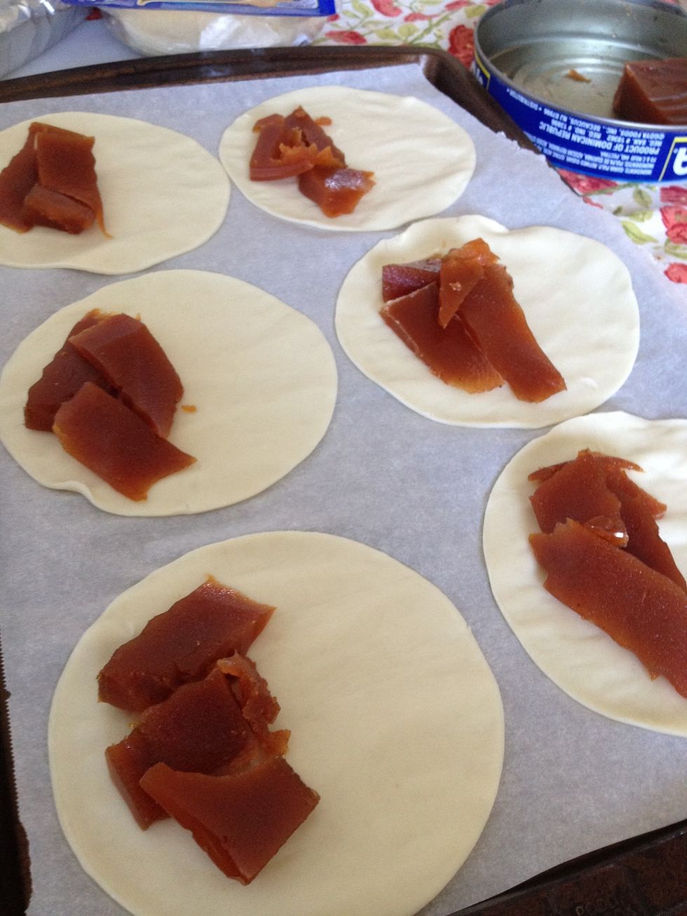 Cut pieces of the guava paste and place them on the pastry circles like this. We're going to be folding these circles over so also leave a small border between the guava paste and the edge.