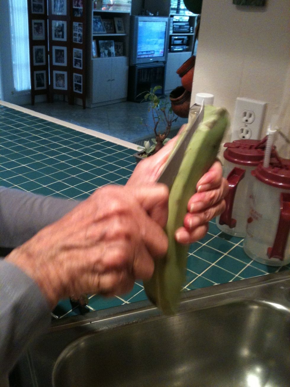 Cut plantain length ways, then pull off peel.