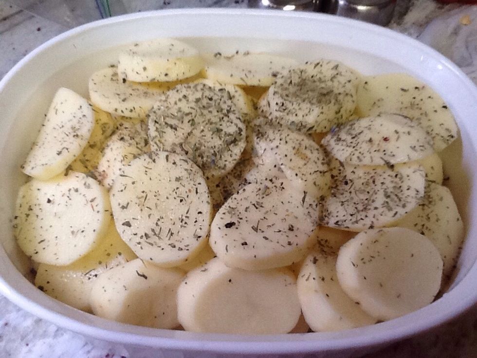 Cut potatoes and lay on top of veggies. Potatoes can be either peeled or unpeeled. Dot remaining butter on top. Sprinkle salt, pepper and herbs to taste. I used oregano, thyme and a little rosemary.
