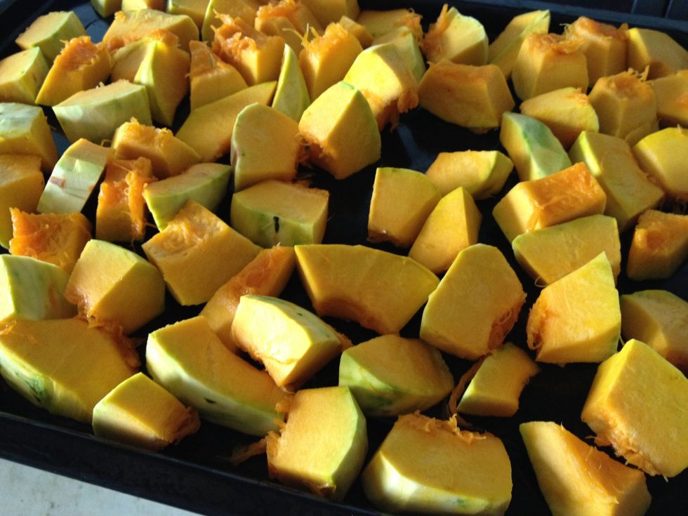 Cut pumpkin into 2cm cubes, spread them on a large baking tray. Preheat oven to 170 deg celcius.