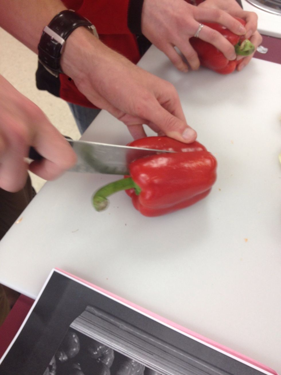 Cut red bell peppers in half