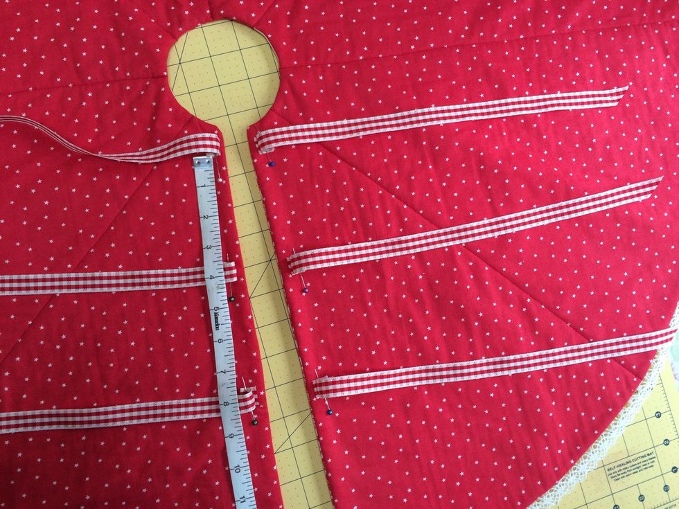 Cut ribbon into 6 equal lengths and sew in place , 3 matching pairs spaced as shown