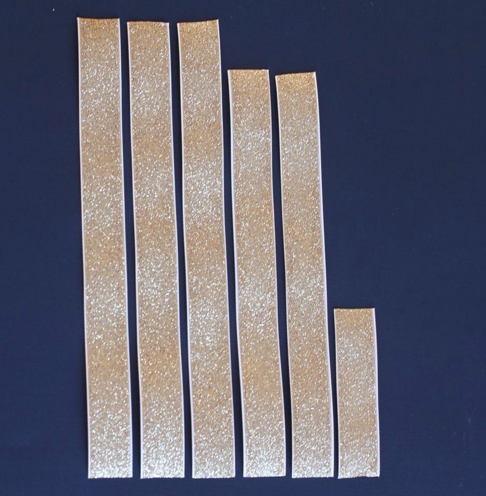 Cut ribbon into strips: three 9.5 inch strips, two 8.5 inch strips, and one 3.5 inch strip. Feel free to experiment with using narrower ribbon and therefore more strips.