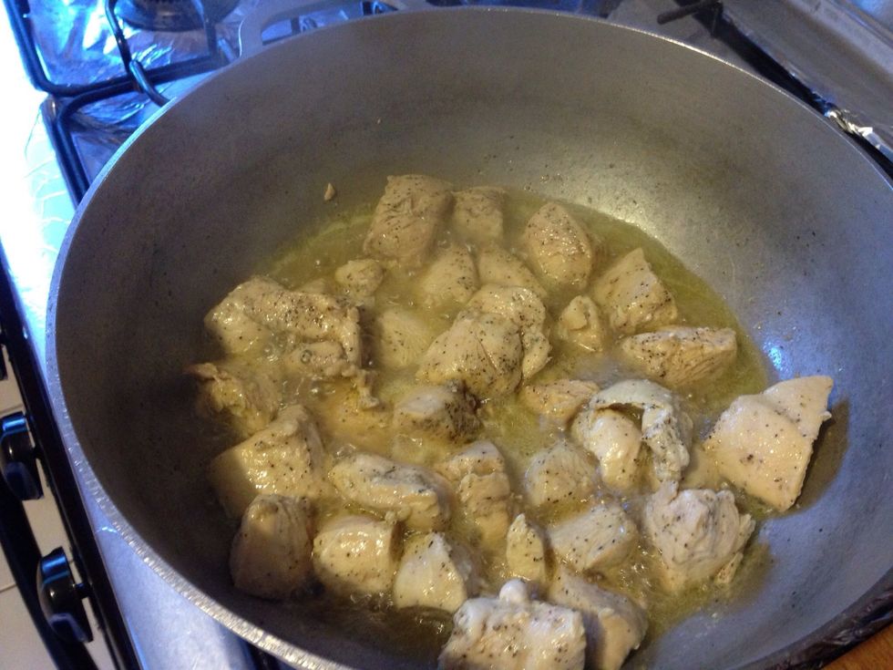 Cut, season and stir fry with garlic on high in 2tbl spoons of oil. Water will be released and help in the cooking and flavor of the chicken. Stir every 5 minutes for 15 mins while boiling.