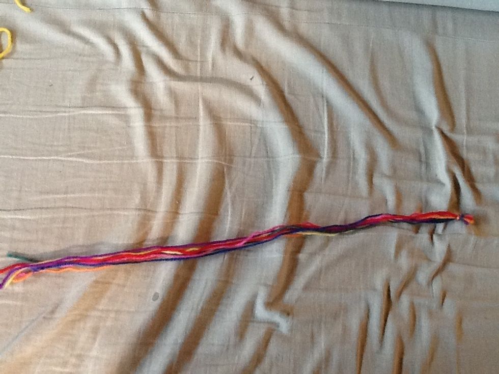 Cut Seven pieces of yarn all the same length dont cut them too small Mine are about 40 cm. And tie a knot in one end