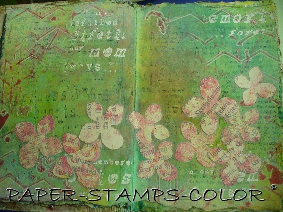 Cut several sizes of flowers from this colored bookpaper, and adhere it to the page as shown.