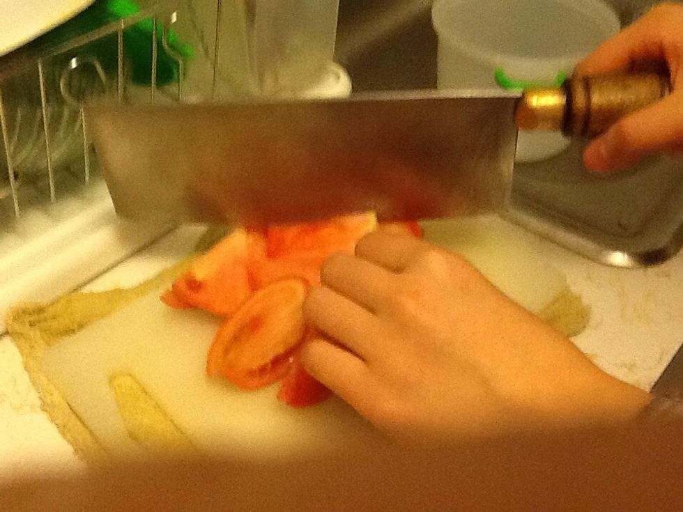 Cut several tomatoes into quartered pieces