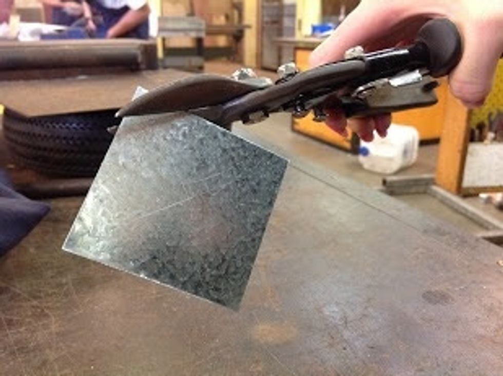 Cut sheet metal with tin snips following the circle line