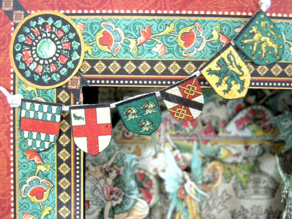Cut shields from Exquisite Epoch and attach to twine. Attach twine to top left corner of front frame.