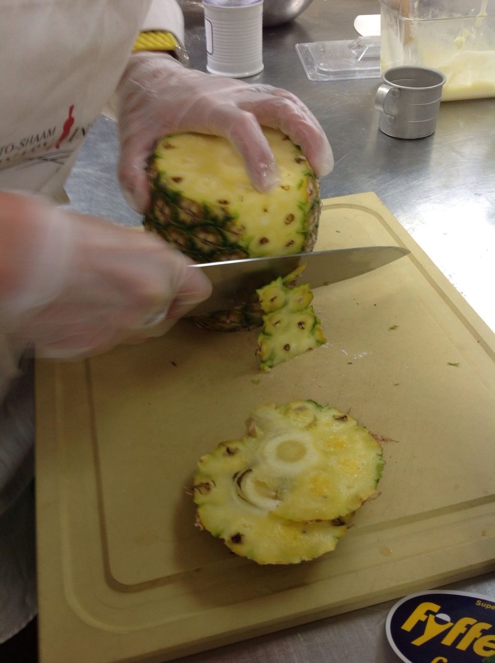 Cut skin off pineapple.