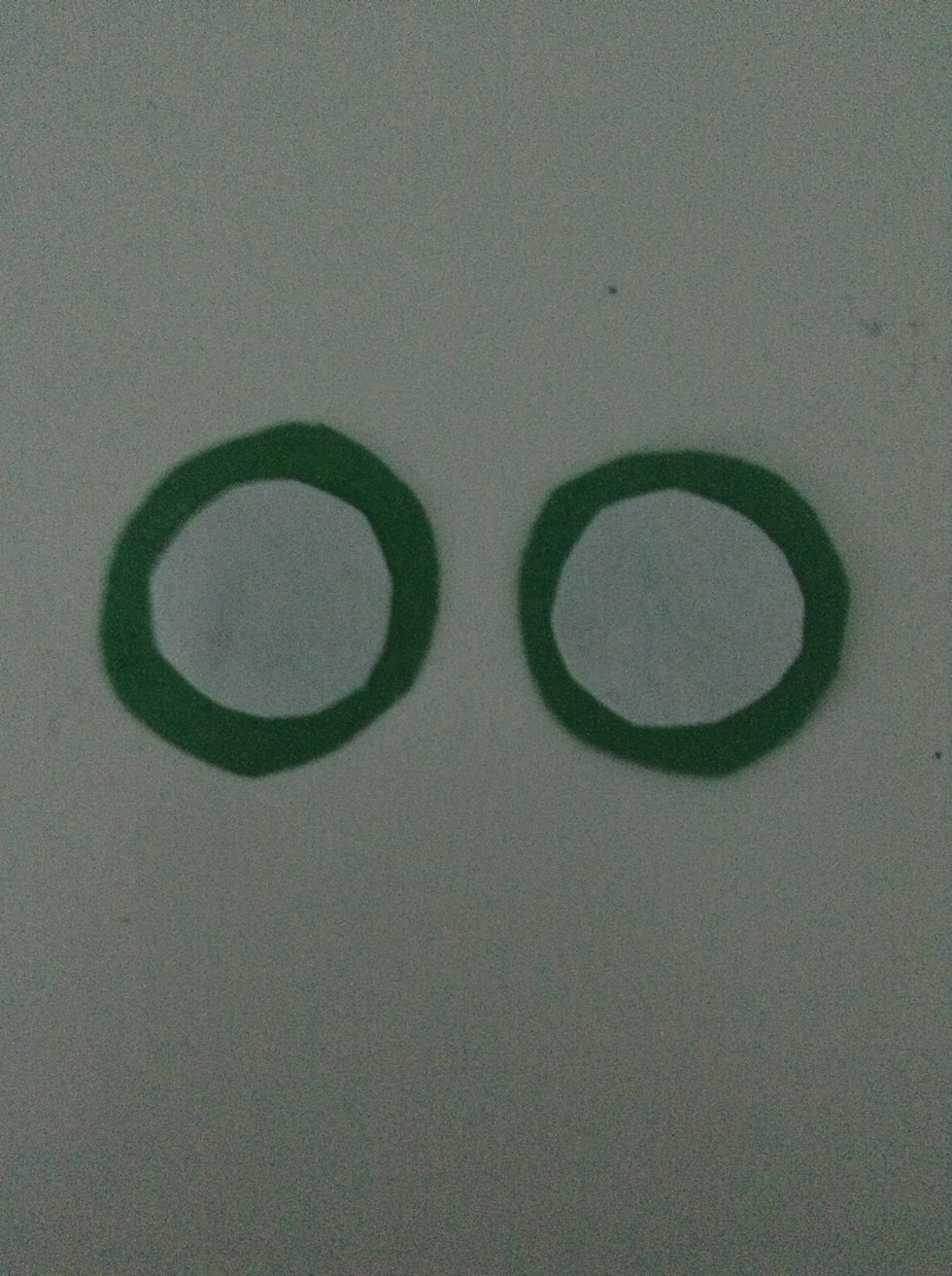 Cut slightly smaller circles out of paper than the ones made of construction paper. Glue the paper circles on top of the construction paper circles.